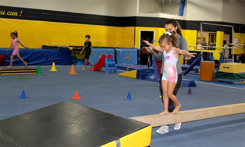 girl walking on balance beam